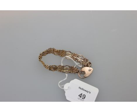 A 19ct gold gate link bracelet with padlock clasp