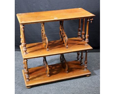 A Victorian walnut canterbury bookcase, the three rectangular tiers with turned fluted columns and pierced, scrolled shelf di