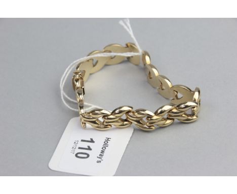 A 9ct gold bracelet,  the polished hollow chevron links to a concealed push button clasp