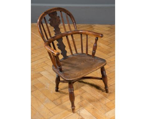 A 19th century child's double hoop and stick back Windsor armchair, having yew rails and splat, elm seat, on ring turned spla