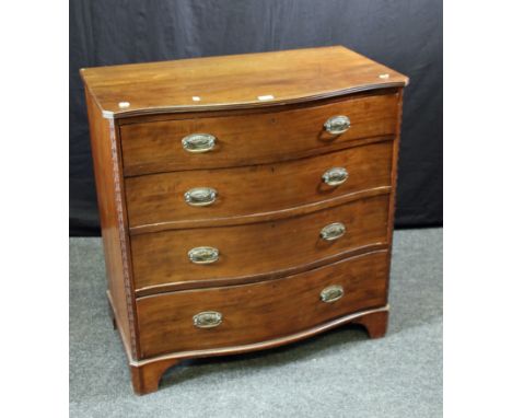 A George III style mahogany serpentine fronted commode chest with carved canted corners, raised on shaped bracket feet, 91cm 