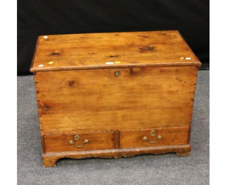 An early 19th century pine mule chest of small proportions, with candle box fitted interior, steel side handles, two drawers 