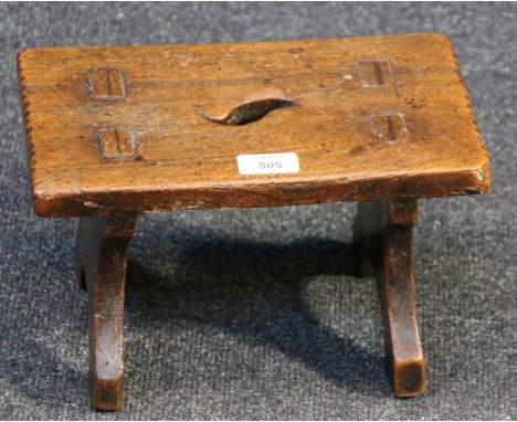 A 19th century primitive elm stool, the pierced rectangular top on shaped bracket feet, 17 x 29 x 18cm