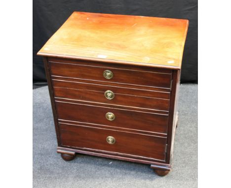 A converted George III mahogany commode chest, the square top with moulded edge over four false drawers with brass drop ring 