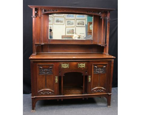 An Art Nouveau period oak dresser, the mirror back with fruiting leaf moulded panels over a bevelled plate and shelf, the bas