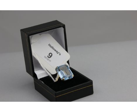 A dress ring, the synthetic step cut blue stone in pierced 9ct gold claw mount