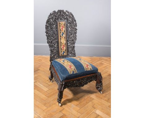 A 19th century Anglo-Colonial padouk side chair, the profusely carved and pierced back decorated with exotic birds and fruiti