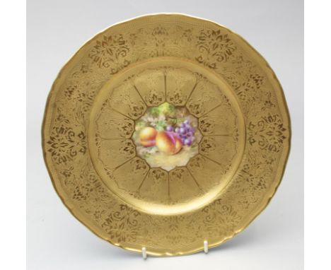 A Royal Worcester fruit painted plate, by M Johnson, the reserve of peaches and grapes within a broad tooled and raised gilt 