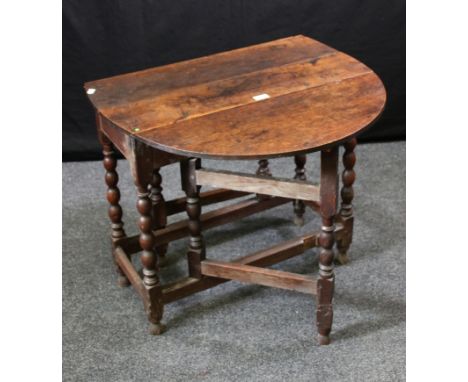 A late 17th century oak bobbin turned oval gate-leg table, 74cm wide