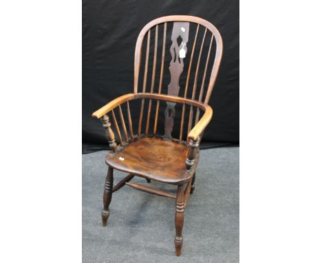 A 19th beech and elm double hoop and stick back Windsor armchair, having a pierced splat, shaped seat, on ring turned taperin