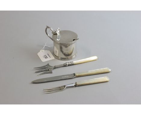 S.I. Ltd, a silver mustard of cylindrical form, with hinged cover, pierced thumbpiece and loop handle, Chester 1923, together