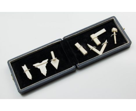 An early 20th century presentation cased set of carved ivory miniature 'working tools', including mawle, square, compass, tro