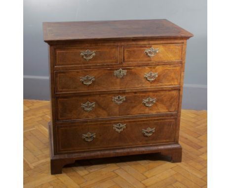 A George III mahogany and boxwood strung chest, the rectangular crossbanded top over two short and three graduated long drawe