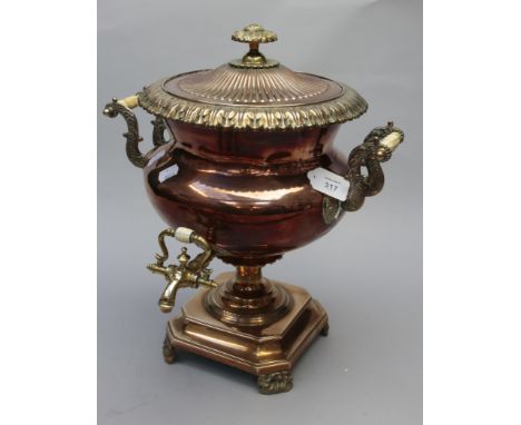 A late 19th century copper samovar, the cover with flower finial over swept reeded and leaf casting, the body having twin scr