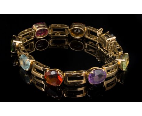A multi gem set line bracelet, the mixed oval cut stones including citrine, tourmaline, amethyst and topaz, with rectangular 