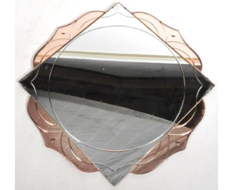A 1930's Art Deco two tone glass frameless wall mirror having a central circular bevelled panel with two tone pink &amp; clea