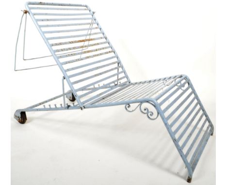A retro vintage mid 20th Century painted wrought iron sun lounger of typical slatted form with a tubular frame and adjustable