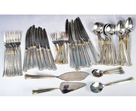 An extensive retro vintage 20th Century SBS Bestecke Solingen German flatware / cutlery set. Silver in colour with gold bands