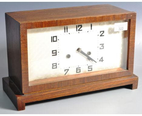 A vintage Art Deco oak cased mantel clock of rectangular form having an etched checkered silvered face with Arabic numeral ch