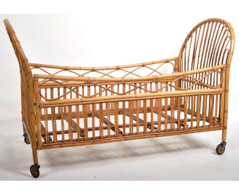 A retro vintage mid 20th Century Italian Boho bamboo &amp; cane Childs crib / cot or bed having two curved ends with various 