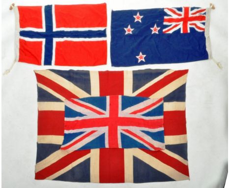 A collection of four vintage 20th Century world flags to include two Great Britain examples, Australian National flag and Nor