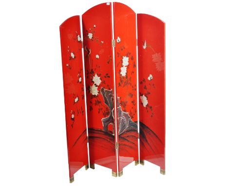 A vintage mid 20th Century Chinese four fold red lacquer dress screen / room divider having two taller panels flanked by smal