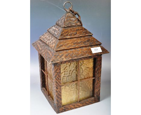 A late 19th Century Arts &amp; Crafts hanging porch lantern lamp light of oak construction having a pyramidal top with iron h