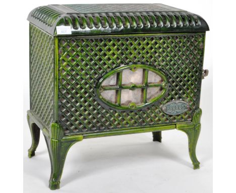 Faunus - A vintage 20th Century French cast iron enamel stove having&nbsp;lattice worked panels throughout with an oval maker