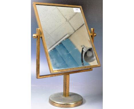 A vintage mid 20th Century brass framed dressing table top / counter top double sided swing mirror of simple form raised on a