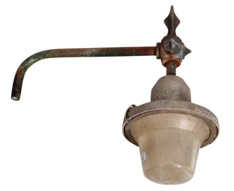 A retro vintage 1950's industrial factory exterior wall mounted light / lamp having a ribbed holophane glass shade with steel