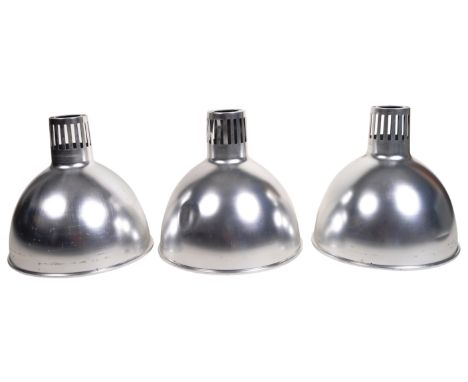 A set of three retro vintage mid 20th Century industrial factory pendant light shades of conical form. Each constructed from 