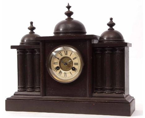 Stained wooden cased mantel clock, the architectural case surmounted by three domes and with half columns on a plinth base to