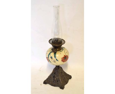 Oil lamp, the globular glass font decorated with stylised flowers, raised on a pierced spreading square, bronzed foot, 58cm h