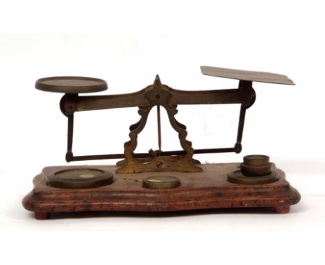 Late 19th century postal scale, the serpentine shaped base set with a pierced frame with shaped pans and fitted with five var