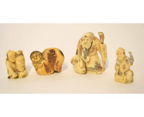 Group of Oriental carvings and netsuke comprising a carving of an immortal with staff plus three other children either as tog