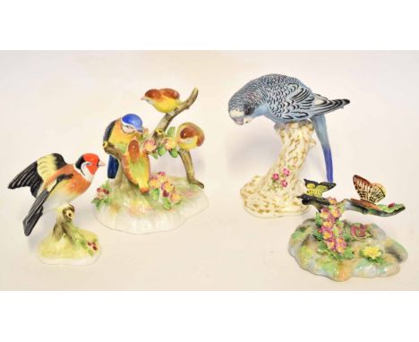 Group of four porcelain models of birds, including two by Royal Doulton and a figure of a budgerigar on a tree stump by Royal