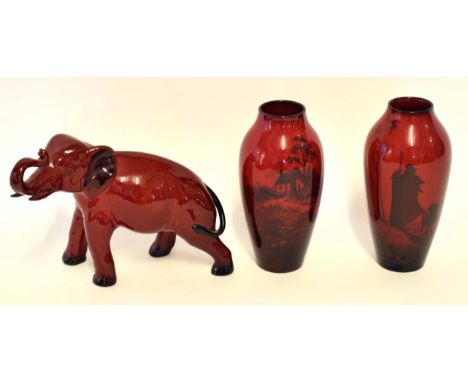 Group of Royal Doulton flambe wares comprising a pair of vases with a cottage design, and an elephant with trunk raised, all 