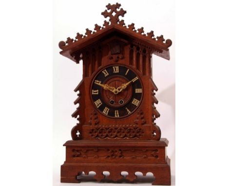 Late 19th century oak cased cuckoo bracket clock, the architectural case with carved and applied Gothic detail and buttressed