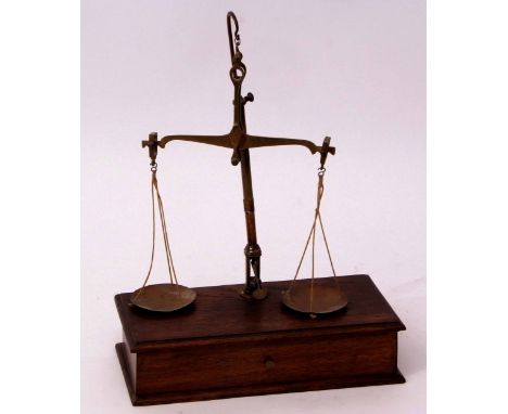 Late 19th century oak cased beam scale, the rectangular base fitted with single drawer containing two glass and two brass pan