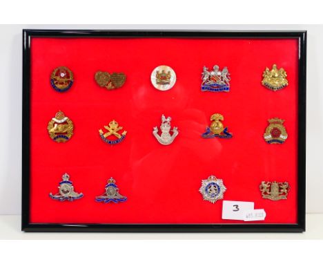A framed display of 20th century sweetheart brooches / badges to include Manchester regiment, Duke Of Lancaster's Own Yeomanr