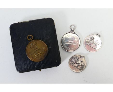Three white metal regimental sporting medals comprising a Loyal North Lancashire Regiment Harris Football Cup, Poona, India a
