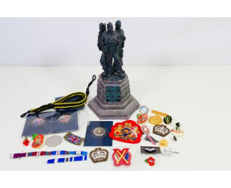 Lot to include military badges and similar and a Commando Memorial model, approximately 23 cm (h). [W]