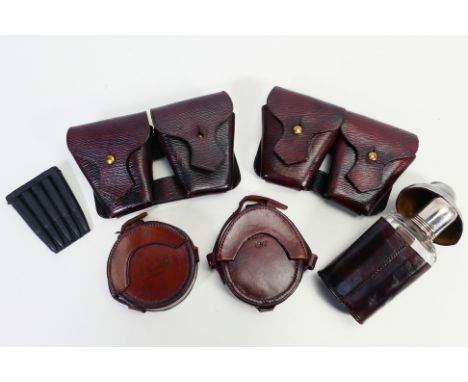 Lot to include two early 20th century leather compass cases, one dated 1900, the other 1917, two leather ammunition pouches a