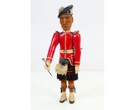A good quality folk art whirligig type figure in the form of a 19th century Scottish army officer, painted carved wooden body