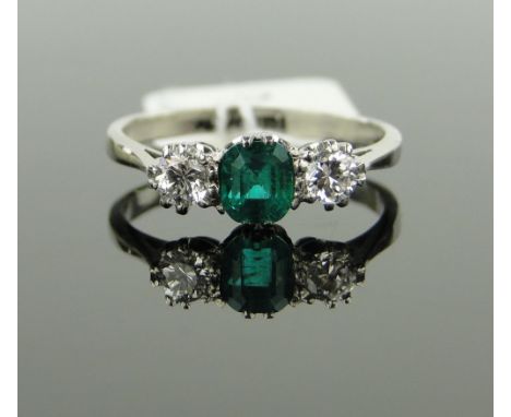 A 3 stone emerald and diamond ring,
emerald approx. 0.53cts, palladium settings, size M.