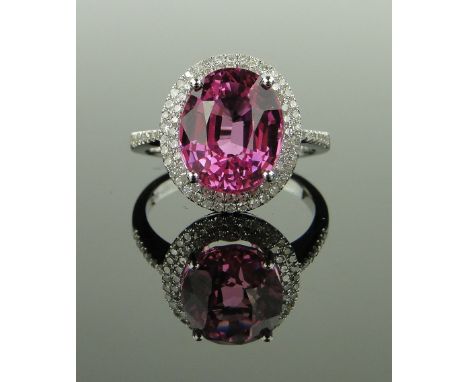 14ct white gold ring set with a pink sapphire,
approx. 6cts surrounded by small diamonds approx. 0.75cts total, setting heigh