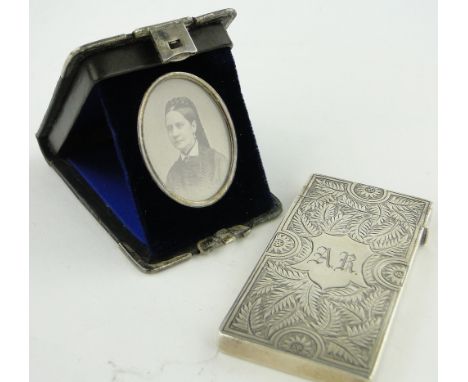 A Victorian engraved silver card case,
Birmingham 1886, height 7.5cm and a leather cased photographic portrait of a lady, (2)