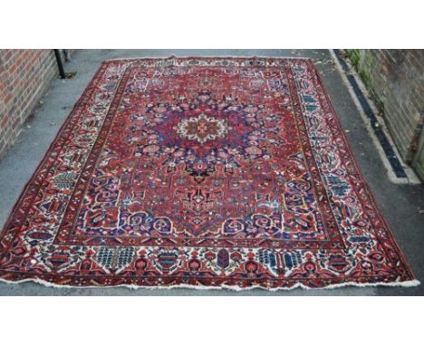 A large red ground Tabriz carpet,
14'8" x 10'8".