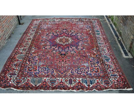 A large red ground Tabriz carpet,
14'8" x 10'8".