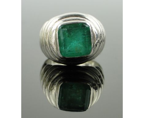 A large square-cut natural emerald ring,
heavy unmarked white gold settings, emerald width 9mm, size L, 14.5gm.